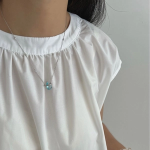 925 sterling silver bamboo necklace with a blue sapphire teardrop pendant on model