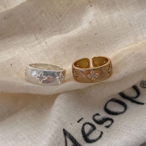 925 silver rings with Italian brushed finish and starburst zircon on a linen pouch