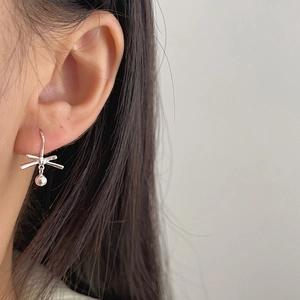 Minimalist 925 sterling silver bow knot earrings with metal beads on female model