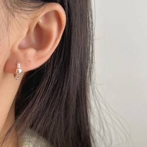 Minimalist S925 sterling silver hoop earring with small bead worn on woman earlobe