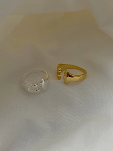 Detail view of gold and silver S925 sterling silver liquid-style adjustable rings