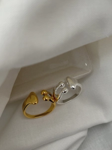 Detailed close-up of asymmetrical teardrop open rings in gold and silver S925 sterling silver