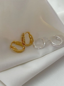 Detailed macro view of S925 sterling silver hoop earrings with twisted rope texture