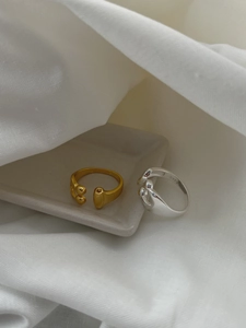 Detailed view of silver and gold asymmetrical water drop rings showing S925 hallmark