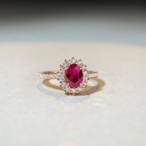 Luxury oval pigeon blood red ruby ring in 18k rose gold halo setting with side diamonds