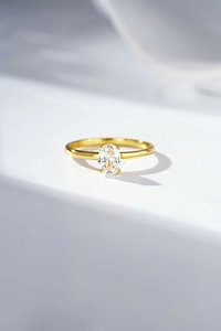 Detailed view of oval cut gemstone ring with gold four-prong minimalist setting