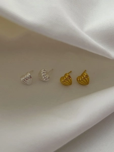 Detail showing 925 sterling silver heart earrings with textured stripe pattern in gold and silver