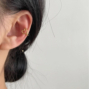 Minimalist S925 sterling silver hollow heart ear cuff in polished gold finish on ear