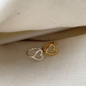 Minimalist S925 sterling silver hollow heart rings in gold and silver finish on linen