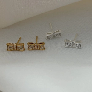Boucles d'oreilles nœud en argent S925 avec zircons brillants en finitions or et argent