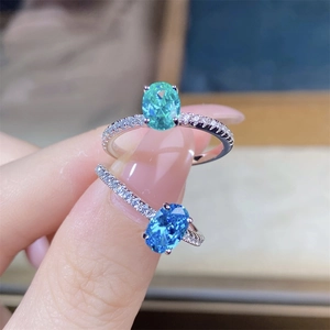 Close-up of S925 sterling silver rings with oval green and blue gemstones and pavé stones