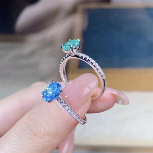 Macro shot of S925 silver ring featuring blue aquamarine and pavé set zircon stones