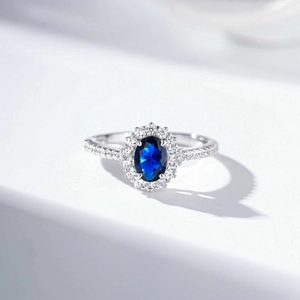 Luxurious S925 silver ring with oval blue gemstone and diamond halo setting