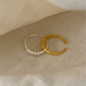 Minimalistische S925 Sterlingsilber Spiralringe in Gold und Silber auf Leinenstoff