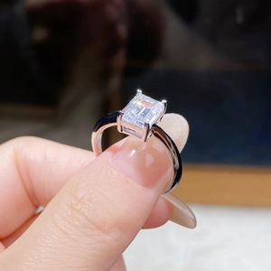 Macro shot of emerald cut moissanite ring with four-prong S925 sterling silver setting