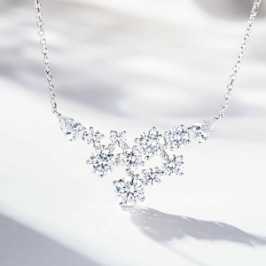 Close-up of S925 silver necklace with V-shaped cluster of blue and white cubic zirconia