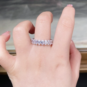 Close-up of S925 sterling silver eternity ring with oval-cut cubic zirconia in claw setting