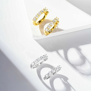 Detailed macro view of S925 sterling silver hoop earrings with five round moissanite stones
