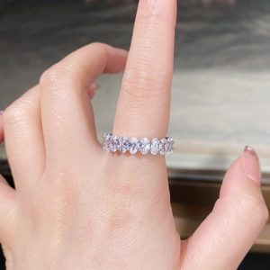Close-up of S925 sterling silver eternity ring with oval-cut cubic zirconia inlays