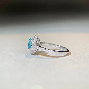 Elegant S925 sterling silver halo ring with oval blue gemstone and side diamonds