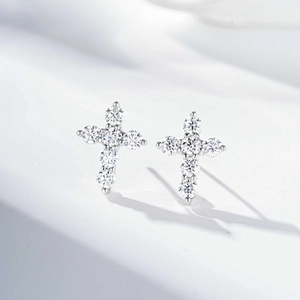 Close-up of S925 silver cross stud earrings featuring brilliant moissanite stones