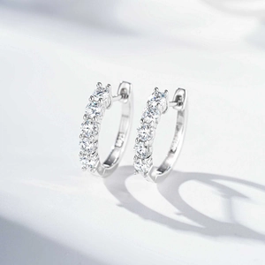 Close-up of S925 sterling silver hoop earrings with four-prong set round cut moissanite