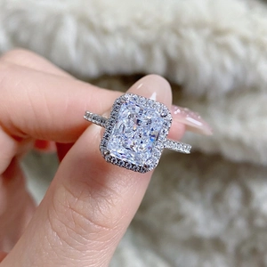 Macro shot of a radiant cut halo engagement ring in S925 sterling silver with pavé band