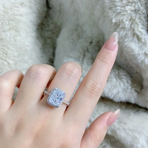 Macro shot of S925 sterling silver ring with radiant cut center stone and halo diamonds