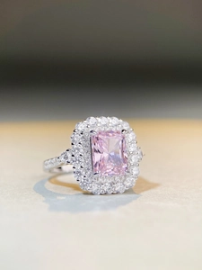 Macro detail of rectangle pink gemstone ring with luxury double halo diamond setting
