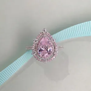 Pear cut pink gemstone ring with double halo diamonds and micro-pave setting