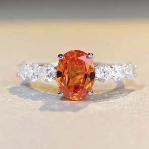 S925 sterling silver ring featuring a 3ct orange oval gemstone with white side stones
