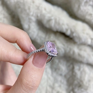Macro view of a 925 sterling silver ring with rectangular pink halo radiant-cut gemstone