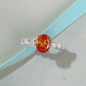 Top view of S925 silver ring featuring an oval orange stone and six side diamonds