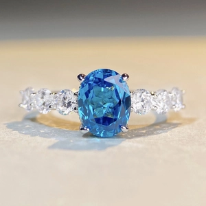 Elegant S925 silver ring featuring an oval blue crystal with zircon accents on the side
