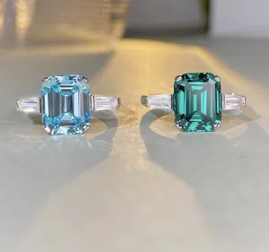 Macro detail of emerald cut aquamarine and blue-green gemstone rings in S925 silver