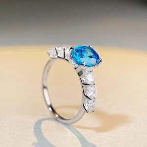 S925 sterling silver ring with round blue gemstone and side zircon accents