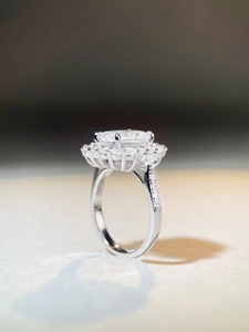 Macro side view of radiant cut 3 carat oval halo engagement ring in silver finish