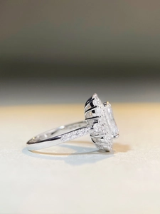 Macro view of a 3-carat radiant cut sparkling ring with side pavé diamond setting