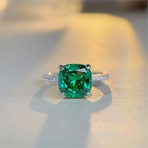 Macro detail of square cut green gemstone ring with pavé diamonds on S925 silver band