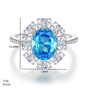 Macro view of halo design ring featuring oval blue zircon and silver metal details