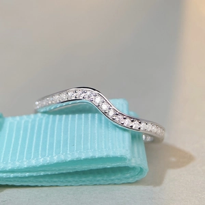 Elegant s925 silver wave ring with pavé cubic zirconia set on a textured blue ribbon