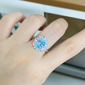 Elegant S925 sterling silver ring with oval sky blue gemstone and halo diamond setting
