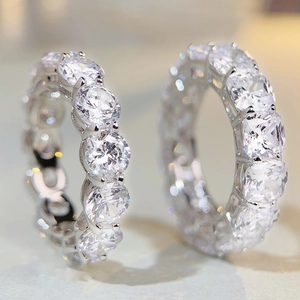 Macro detail of S925 silver eternity rings featuring round and cushion cut sparkling stones