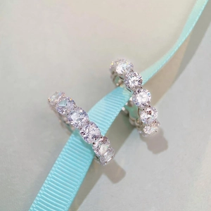 Close-up of S925 sterling silver hoop earrings with full pave cubic zirconia on ribbon