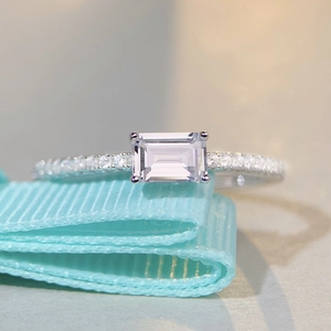 Elegant S925 sterling silver ring with emerald cut crystal and pavé band on blue ribbon