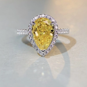 S925 sterling silver ring with pear-cut yellow gemstone and halo diamond setting