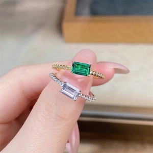 Close-up of emerald-cut rings in gold and silver with sparkling pave-set diamonds