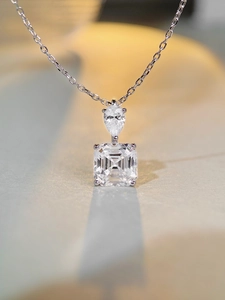 Detail of S925 sterling silver necklace featuring pear and square cut cubic zirconia