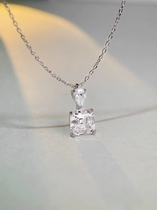 Macro detail of S925 silver necklace with pear and square cut cubic zirconia stones