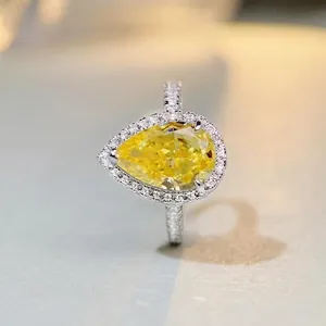 Pear-cut yellow gemstone ring with halo diamond setting in 925 sterling silver